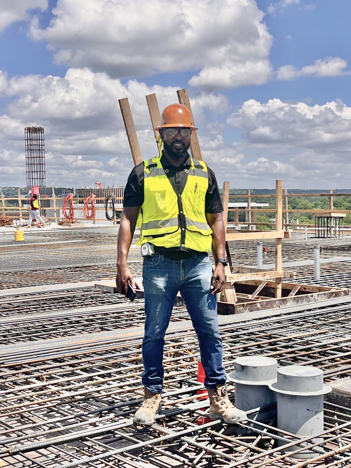 Brandon Rippy on a reinforced concrete deck, hard hat and high-visibility vest